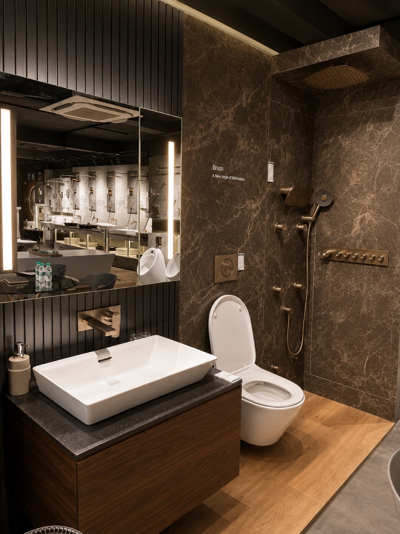 Kohler Brazn bathroom suite with brushed brass shower column and wall-hung WC at Tayo Living, Gurgaon