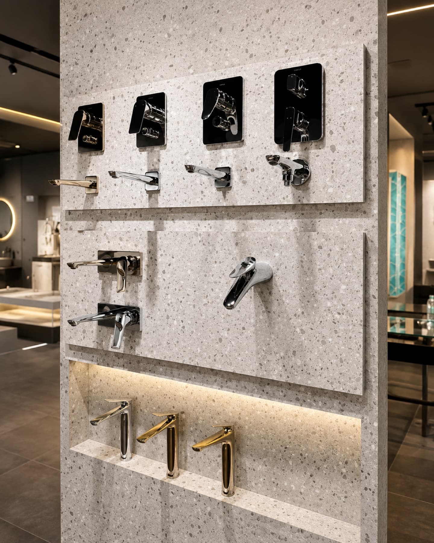 Kohler faucet display wall with concealed mixers and basin faucets in gold, chrome and matte black at Tayo Living, Gurgaon