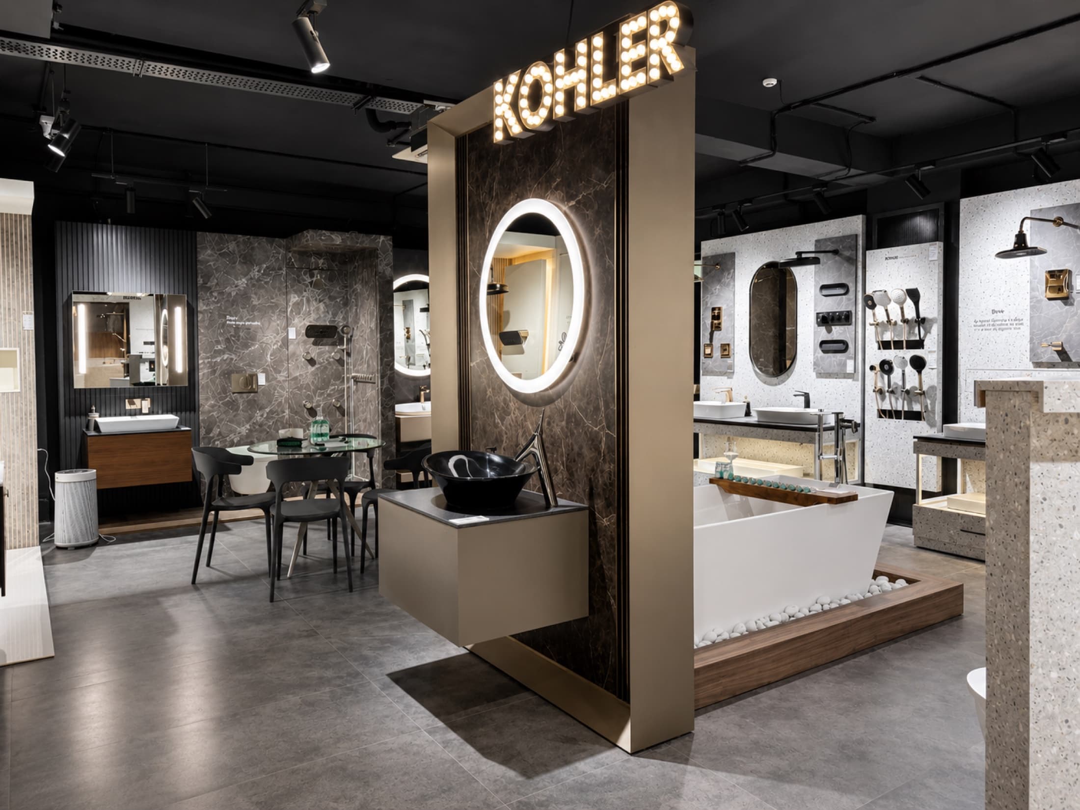 The Kohler showroom at Tayo Living, Gurgaon — lit KOHLER marquee over vessel basins, freestanding bathtub and faucet displays