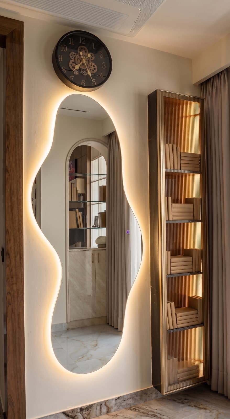 Sculpted designer mirror on a feature wall