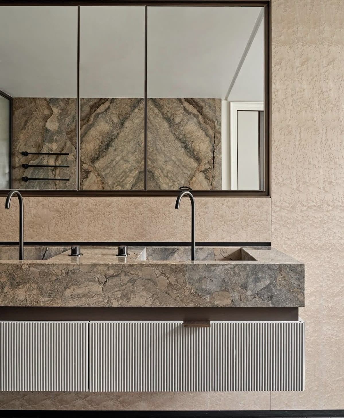 Double-basin stone vanity with mirrored cabinet